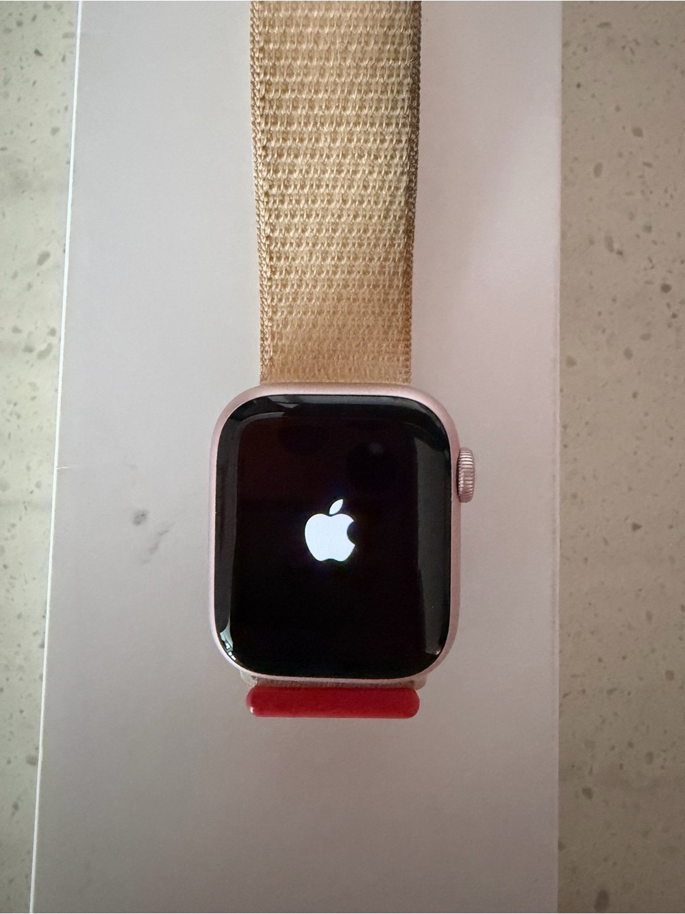 Apple Watch in Pink Aluminum with Gold Woven Nylon Band and Red Accent